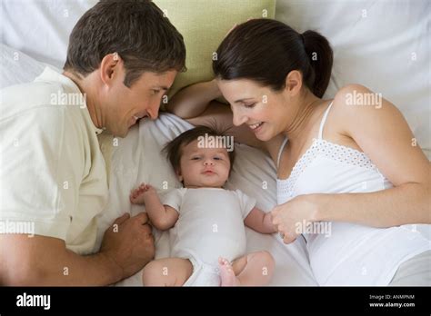 Parents smiling at baby Stock Photo - Alamy