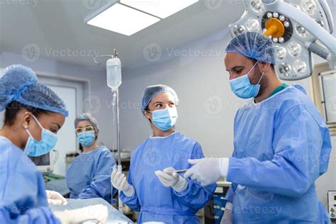 Surgical team performing surgery in modern operation theater,Team of ...