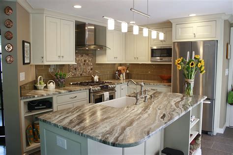 This kitchen features Brown Fantasy Leathered quartzite countertops paired with a glass tile ...