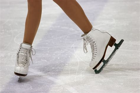 Close Up Of Figure Skaters Feet In Skates On Ice Stock Photo - Download Image Now - iStock