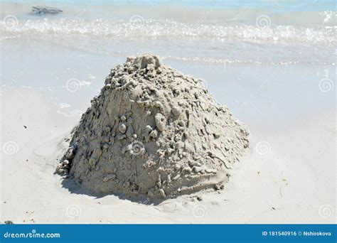 Pile of sand on the beach stock photo. Image of pyramid - 181540916