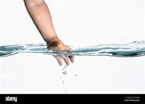 Surface level view of toddlers hand reaching into clear water Stock ...