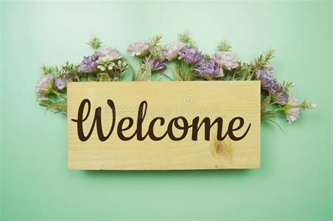 Welcome Sign with flowers frame decorate on green background. Top View ...