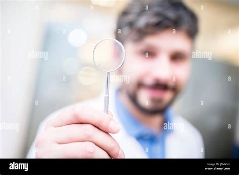 Optometrist holding magnifying glass Stock Photo - Alamy