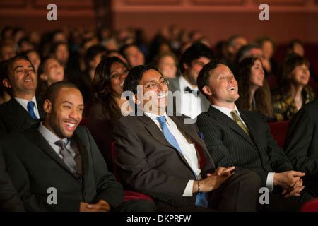 Laughing theater audience Stock Photo - Alamy