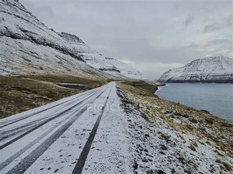 Snowy road in the Faroe Islands — amazing, cold - Stock Photo | #453813056