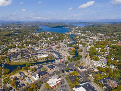 Laconia city center and Opechee Bay of Lake Winnipesaukee aerial view with fall foliage in ...