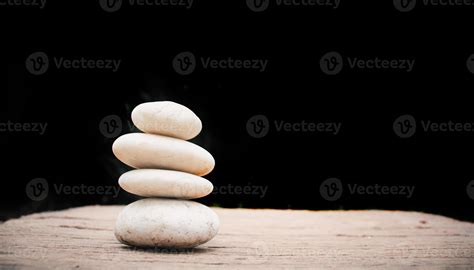 Zen stones on wooden on black background. 7252105 Stock Photo at Vecteezy