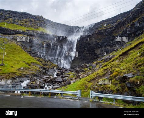 Waterfall Fossa (Fossá) during strong wind in rainy weather, Streymoy Island, Faroe Islands ...