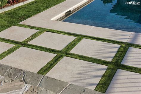 These Lueders limestone pavers are inset into the lawn to define the transition from patio to ...