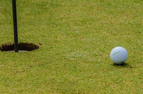 Golf Ball Next To Hole Free Stock Photo - Public Domain Pictures