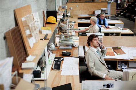 Business people working in busy office - Stock Photo - Dissolve