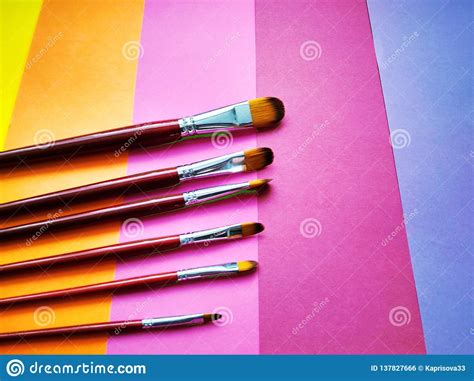 Paint Brushes on a Background of Colored Paper Stock Photo - Image of paint, acryl: 137827666