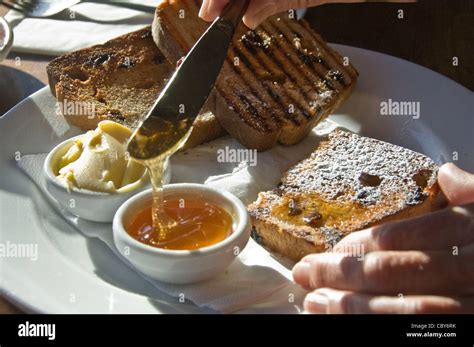 Toast butter and honey breakfast Stock Photo - Alamy