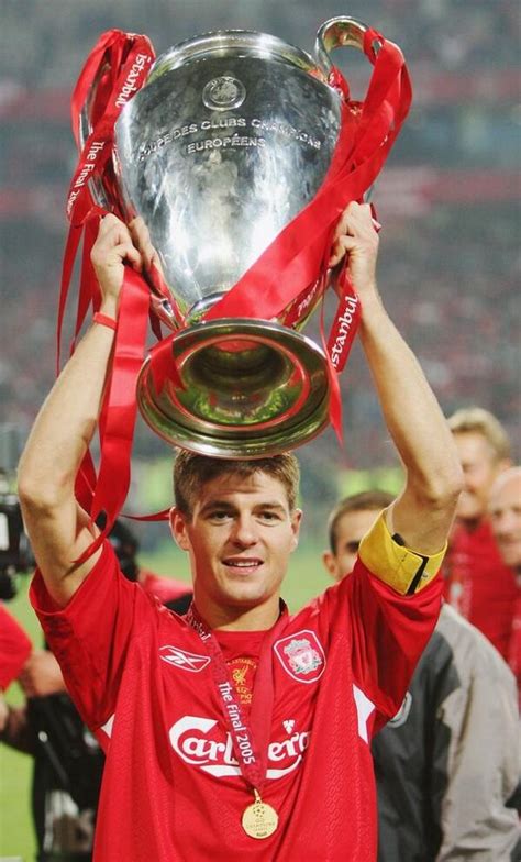 a man holding up a silver trophy on top of his head