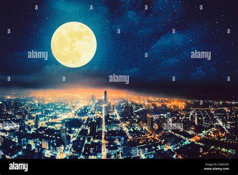 aerial view of city at night with full moon Stock Photo - Alamy