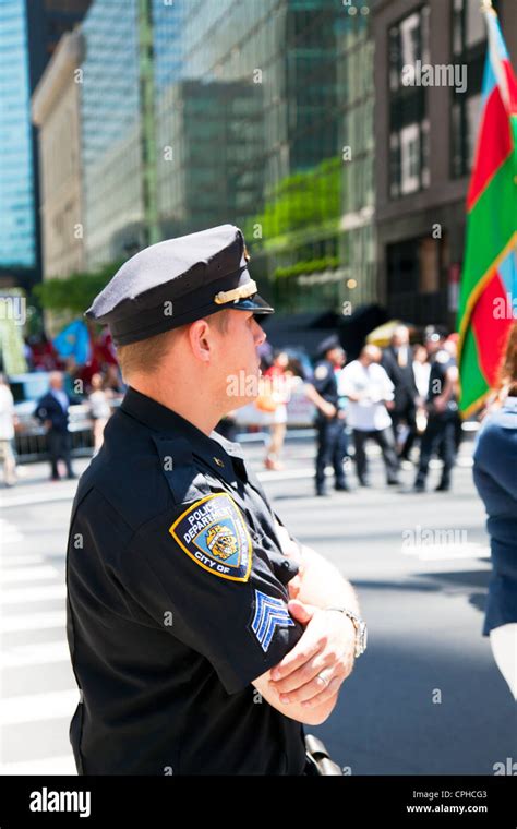 close detail of NYPD police officer and badge on shoulder of uniform from side view on street of ...