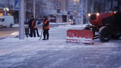 Cleaning car plowing snow to the side of the street. Cleaning the side of the road after a ...