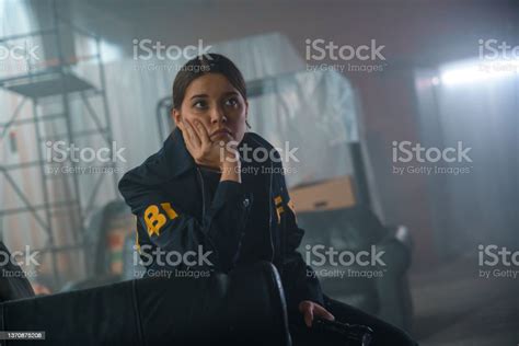 Sad Female Fbi Agent Seats In A Leather Armchair And Looks Away In ...