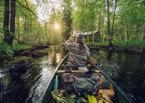 "Back View Of A Woman Canoeing In A Vibrant Lake At The Sunset" by ...