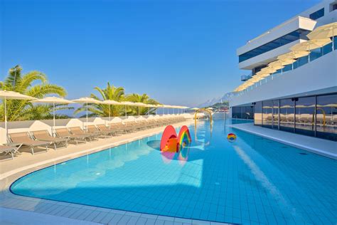 The hotel has two outdoor heated swimming pools with a sun deck, chairs ...