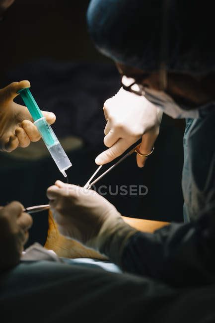 Surgeon making Achilles tendon operation — body part, tools - Stock ...