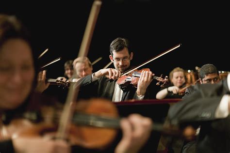 Violin Players In Orchestra by Hybrid Images