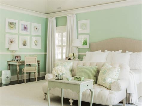 a living room with green walls and white furniture in the center, along ...