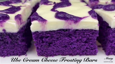 purple cake with white frosting and blueberries on top that says we ...