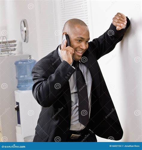 Businessman Leaning On Wall Talking On Cell Phone Stock Images - Image: 6602154