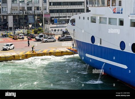 Piraeus, Athens, Greece - June 2022: Large ferry being guided into dock by a dock worker in the ...