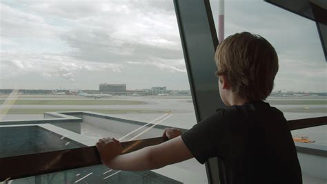 Young traveller likes watching departing planes at the airport 28333122 Stock Video at Vecteezy