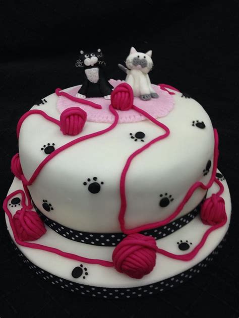 Cat cake with 2 fondant cakes on rug with balls of wool and paw prints (With images) | Cat cake ...