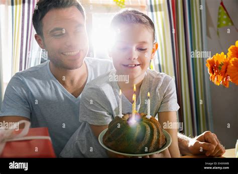 Father and son with birthday cake Stock Photo - Alamy