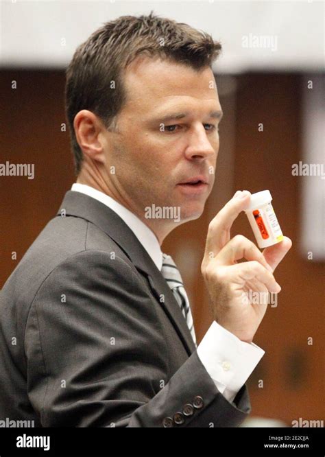 Deputy District Attorney David Walgren holds a prescription bottle as he questions LAPD ...