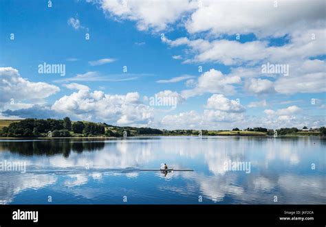 A rower enjoys the sunny weather on Hollingworth Lake in Greater Manchester Stock Photo - Alamy