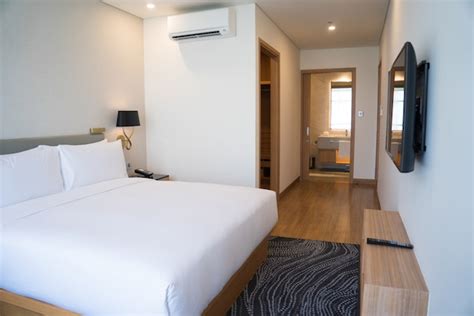 Free Photo | Small hotel room interior with double bed and bathroom.