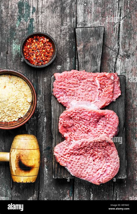 Raw veal chop steak on kitchen Board with spices Stock Photo - Alamy