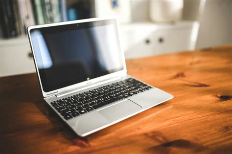 Opened laptop computer on a wooden desk · Free Stock Photo