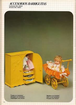 an old fashioned yellow mailbox with a doll in it next to a toy horse and buggy