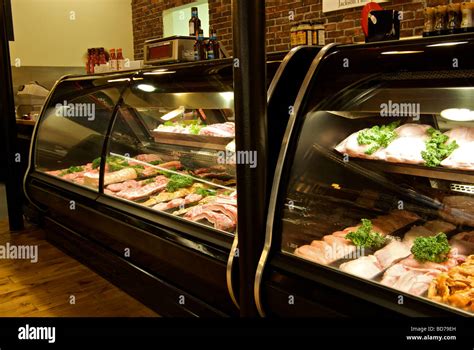 Glass fronted meat display cooler cases in butcher shop Stock Photo - Alamy