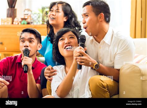 Asian people singing at karaoke party and having fun Stock Photo - Alamy