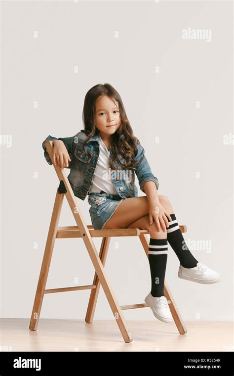 Full length portrait of cute little kid girl in stylish jeans clothes ...