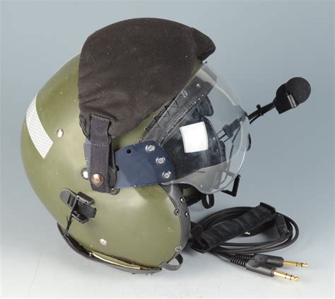 A pilot's flying helmet with leather inner and built in headphones, microphone and double visor b