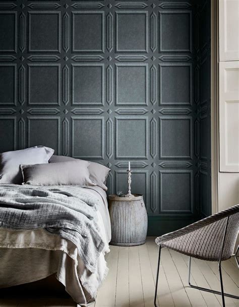 A gray bedroom with a beautiful wallpaper that provides texture to the ...