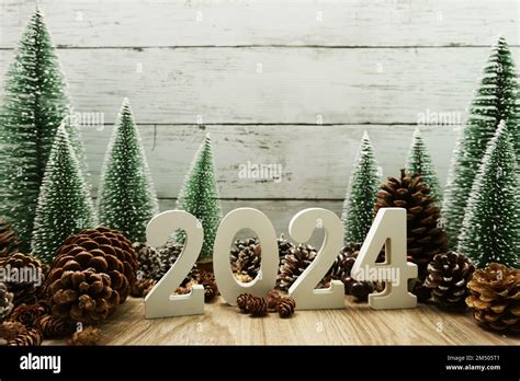 Happy New year 2024 decoration with Christmas tree and pine cones on ...