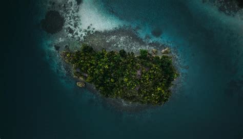 Aerial Photography Of Boat Sailing Near Island · Free Stock Photo