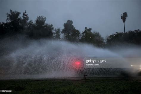 ENCINO, CA - FEBRUARY 24, 2023 - A car is framed by water at a... News ...