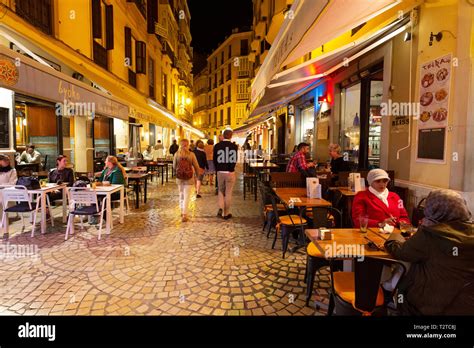 Malaga restaurants - Street with people sitting eating in restaurants ...