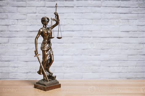 Lady Justice or Justitia the goddess of justice statue on desk - legal ...